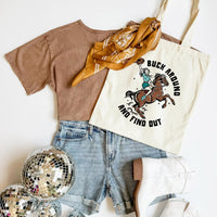 Brown t-shirt, denim shorts, gold scarf, and tote bag with horse graphic on a white background