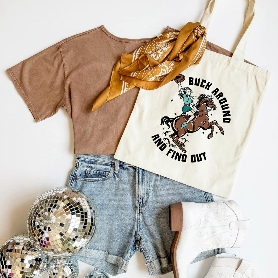 Brown t-shirt, denim shorts, gold scarf, and tote bag with horse graphic on a white background
