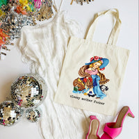 Tote bag with a colorful design and text, surrounded by disco balls and high heels on a white surface.