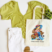 Green top, white pants, beige sandals, and tote bag with vintage-style illustration on a white background