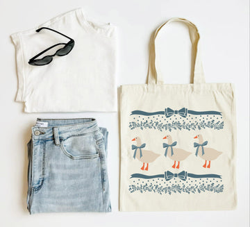 White tank top, blue jeans, sunglasses, and a tote bag with duck design on a white background