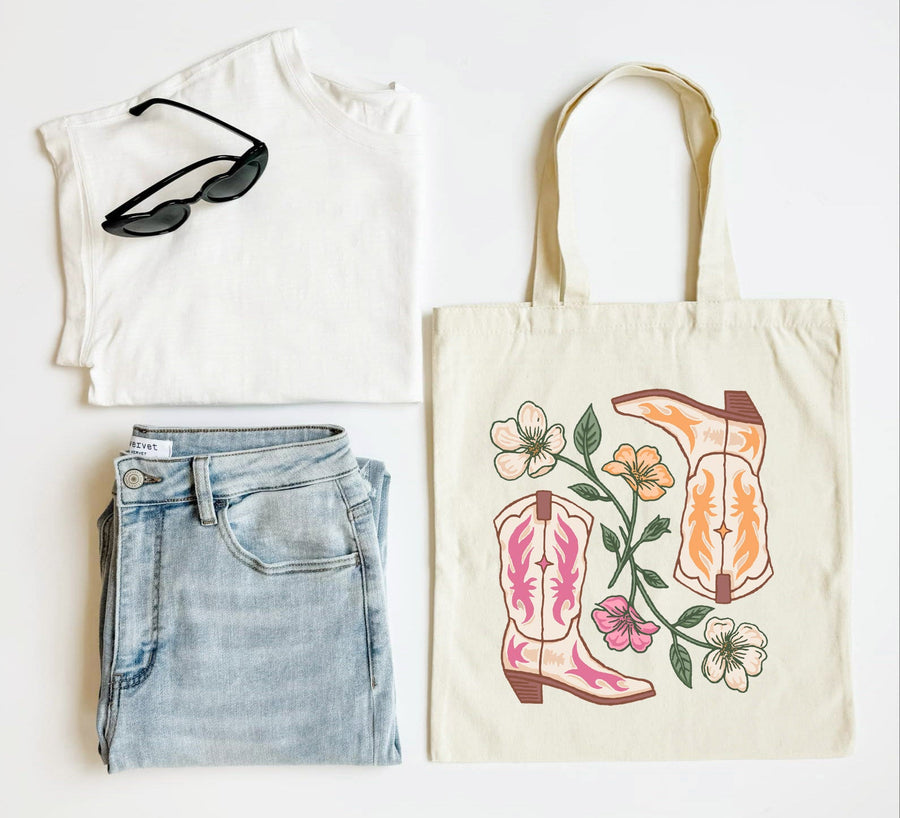 White tank top, blue jeans, sunglasses, and a tote bag with cowboy boot design on a white background