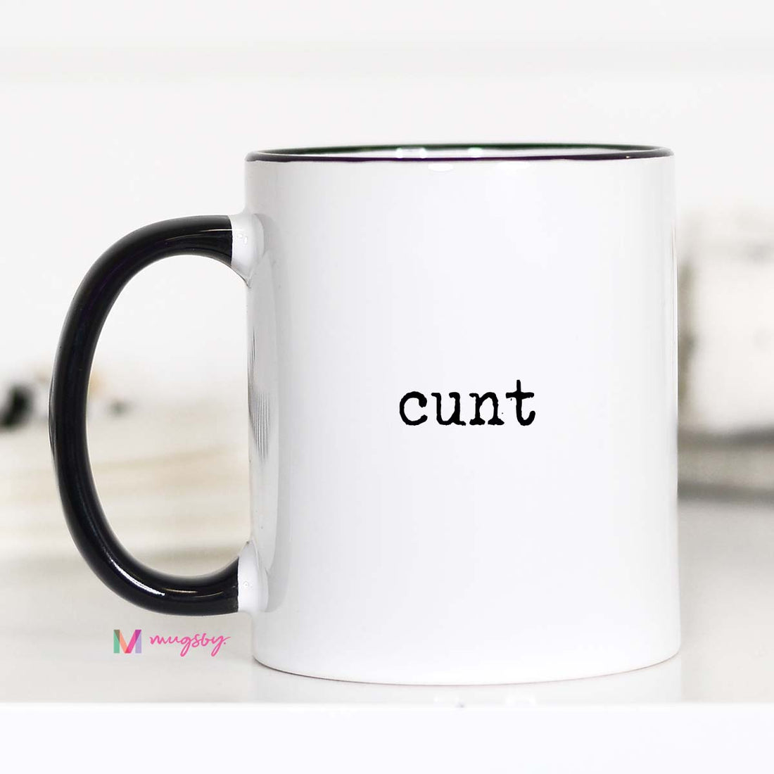 White mug with black handle and &