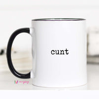 White mug with black handle and 'cunt' printed on it, featuring the brand 'mugsby'.