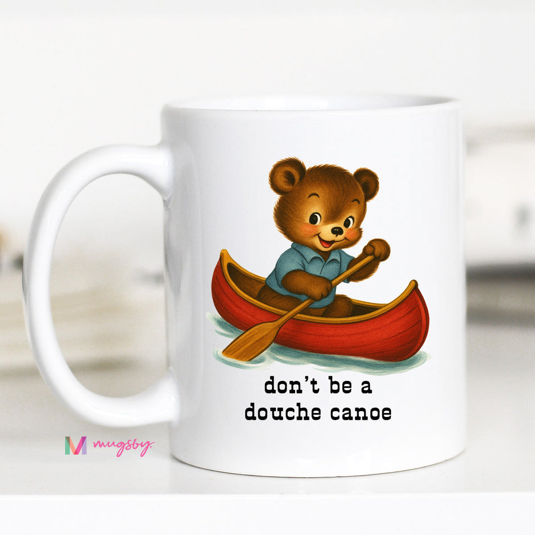White mug with a bear in a canoe illustration and text &
