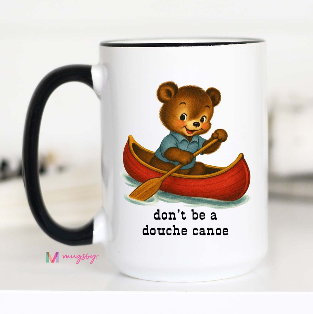 Mug with a bear in a canoe illustration and text &