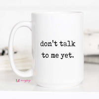 White mug with 'don't talk to me yet' text on a white background