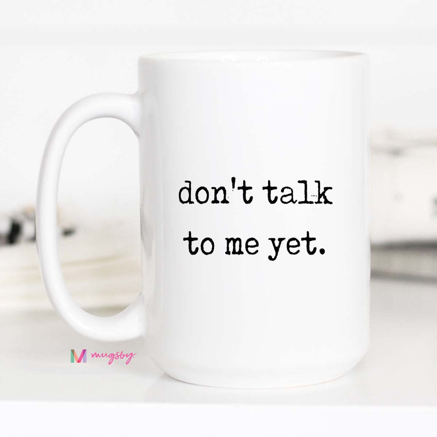 White mug with 'don't talk to me yet' text on a white background