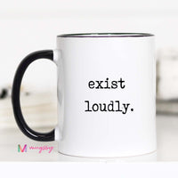 White mug with black interior and handle, featuring the text 'exist loudly.' on a white background.