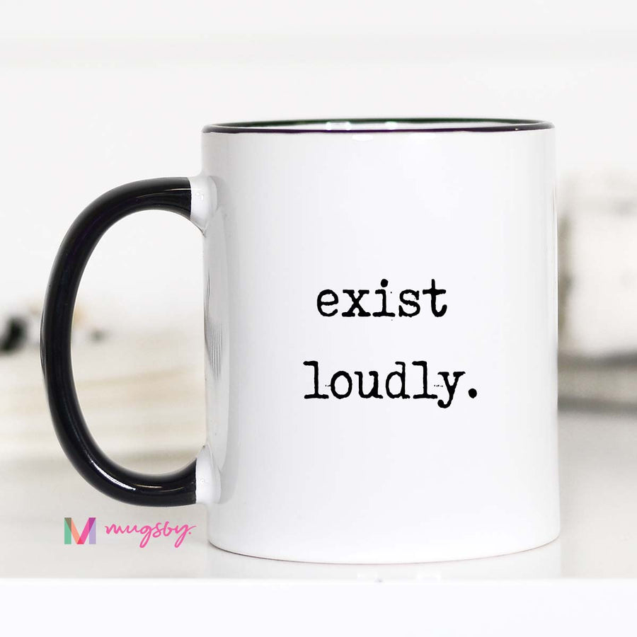 White mug with black interior and handle, featuring the text 'exist loudly.' on a white background.