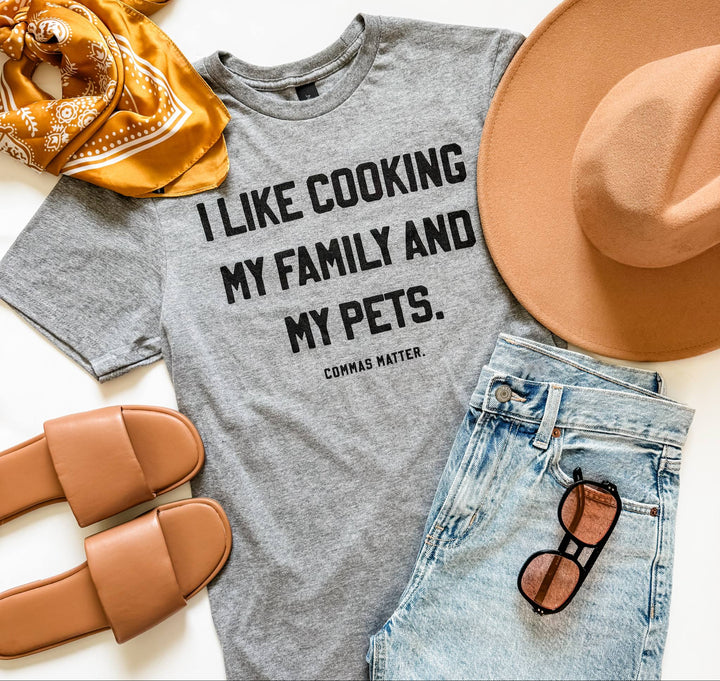 Funny grammar shirt that says 'I like cooking my family and my pets' – punctuation joke t-shirt on Gildan softstyle