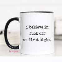 Mug with text 'i believe in fuck off at first sight' on a white background