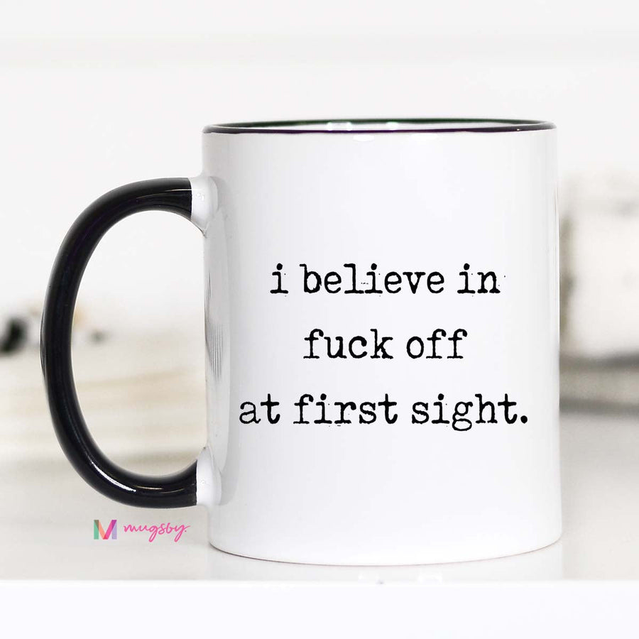 Mug with text 'i believe in fuck off at first sight' on a white background