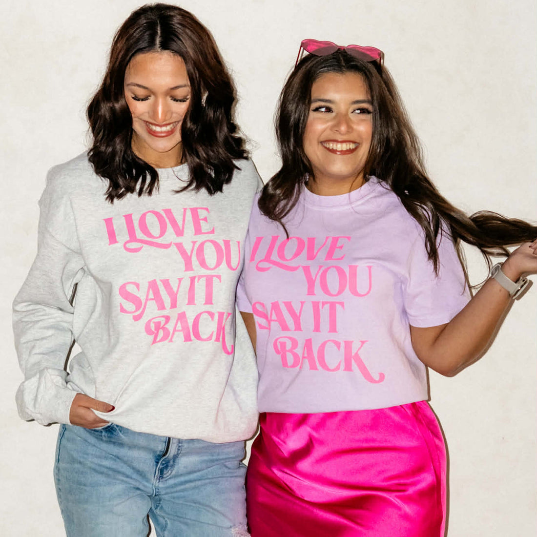 Two women wearing shirts with &