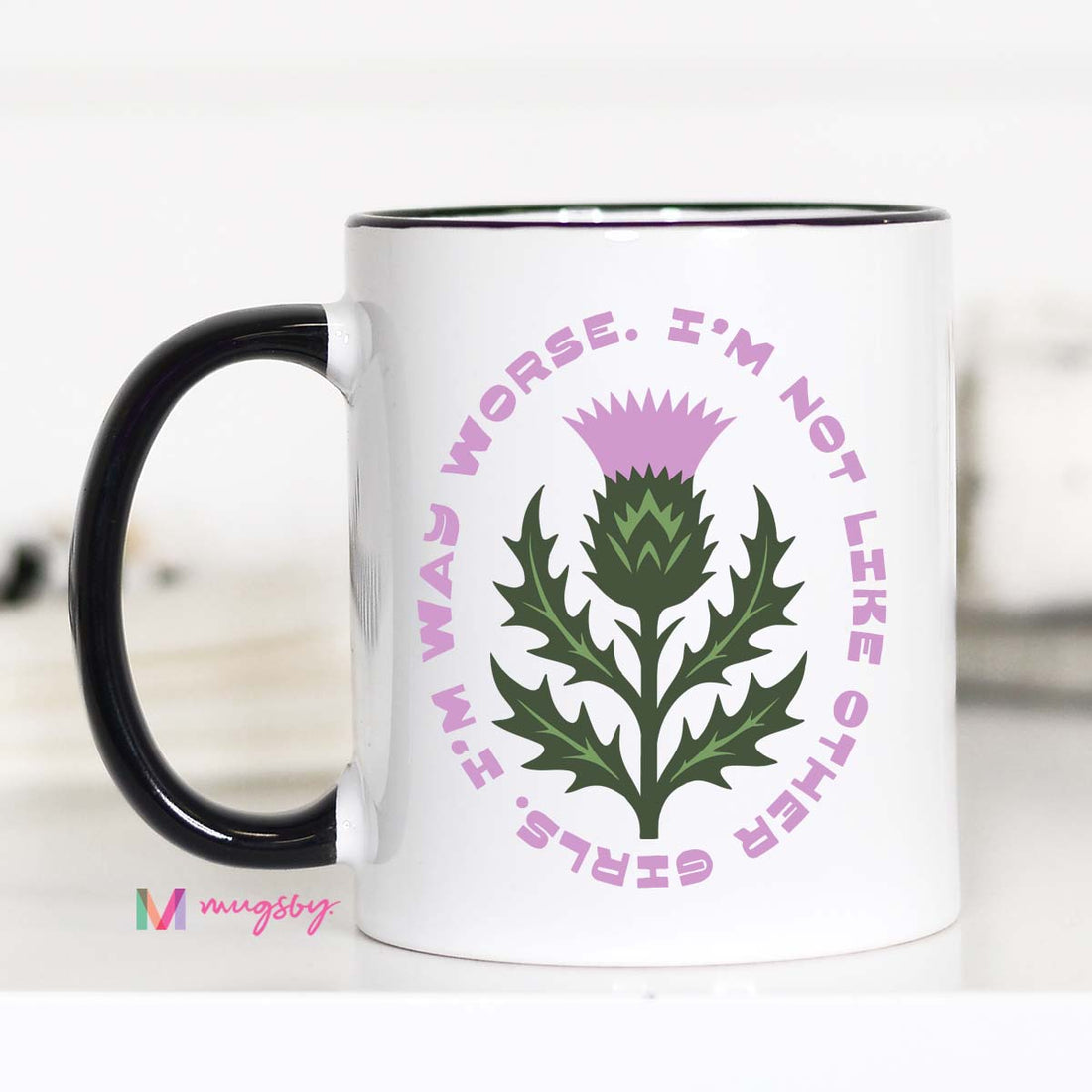 Mug with a thistle design and text on a white background