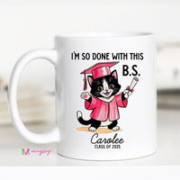 A personalized coffee mug with a cartoon image of a cat wearing a graduation cap and gown, holding a diploma, with the text 'I'M SO DONE WITH THIS B.S.