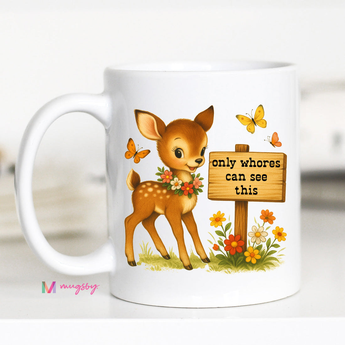 White mug with a cartoon deer and sign graphic on a white background