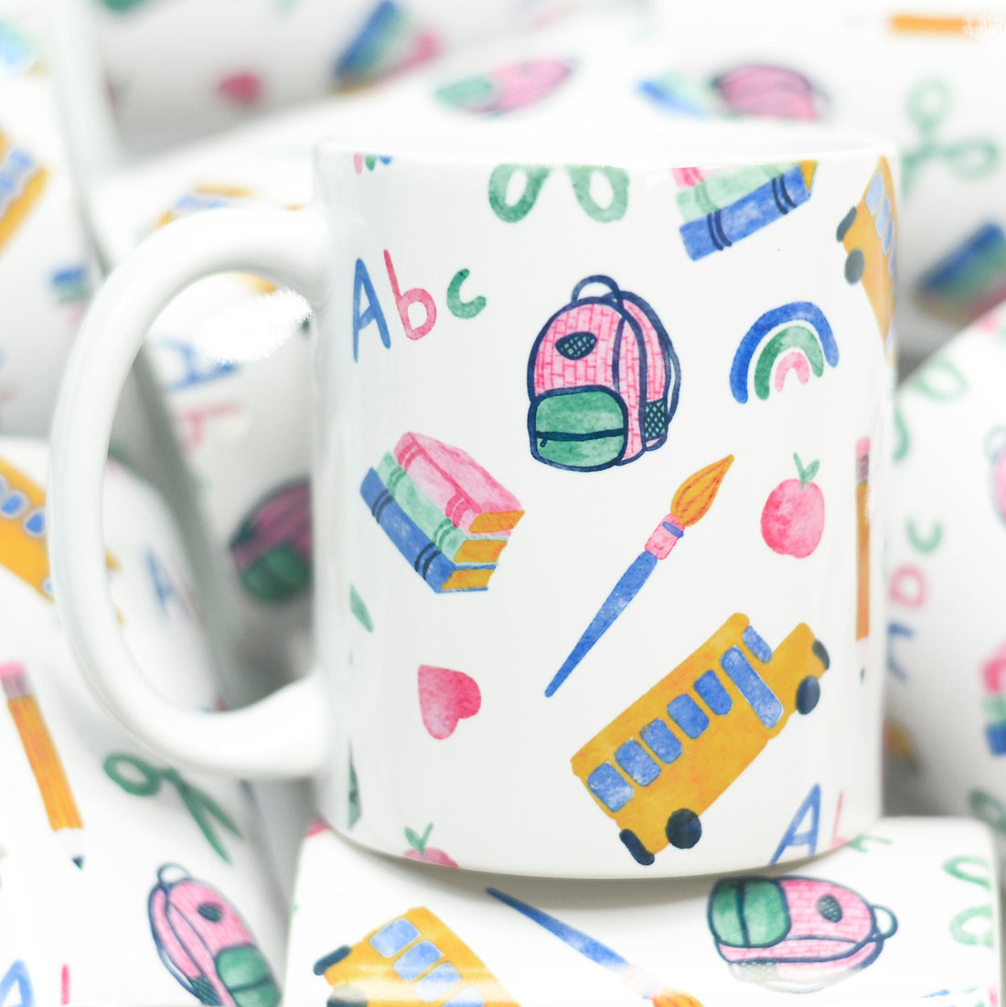 Back to school Mug featuring books, backpack, school bus apples, heart and rainbows