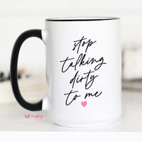 White mug with black text 'stop talking dirty to me' and a pink heart on a white background