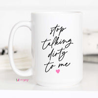 White mug with black text 'stop talking dirty to me' and a pink heart on a white background