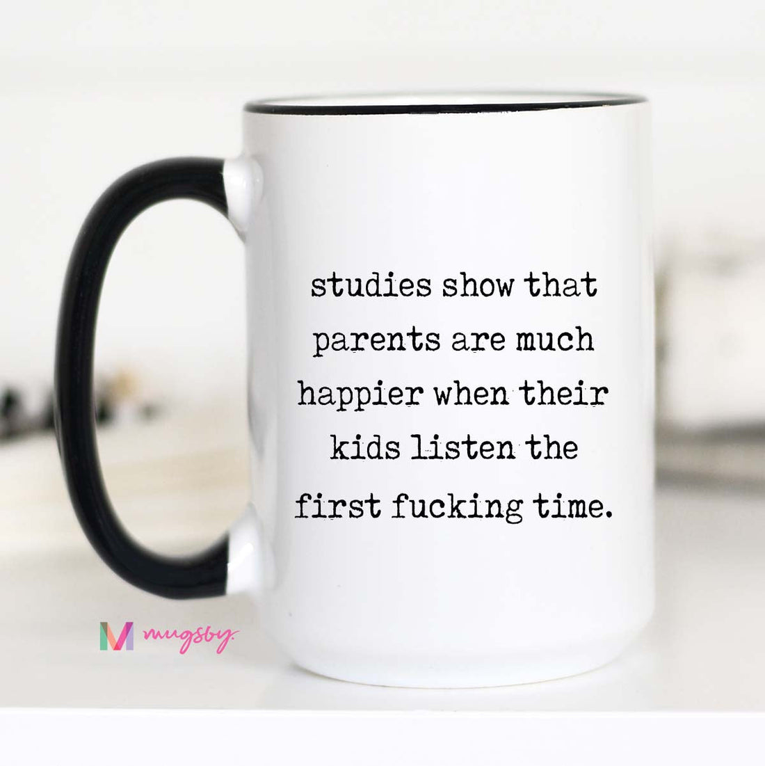 White mug with black text and handle on a white background