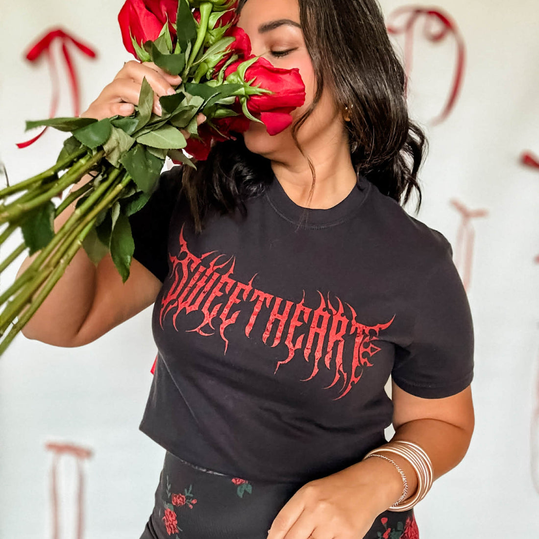 Person wearing a black t-shirt with &