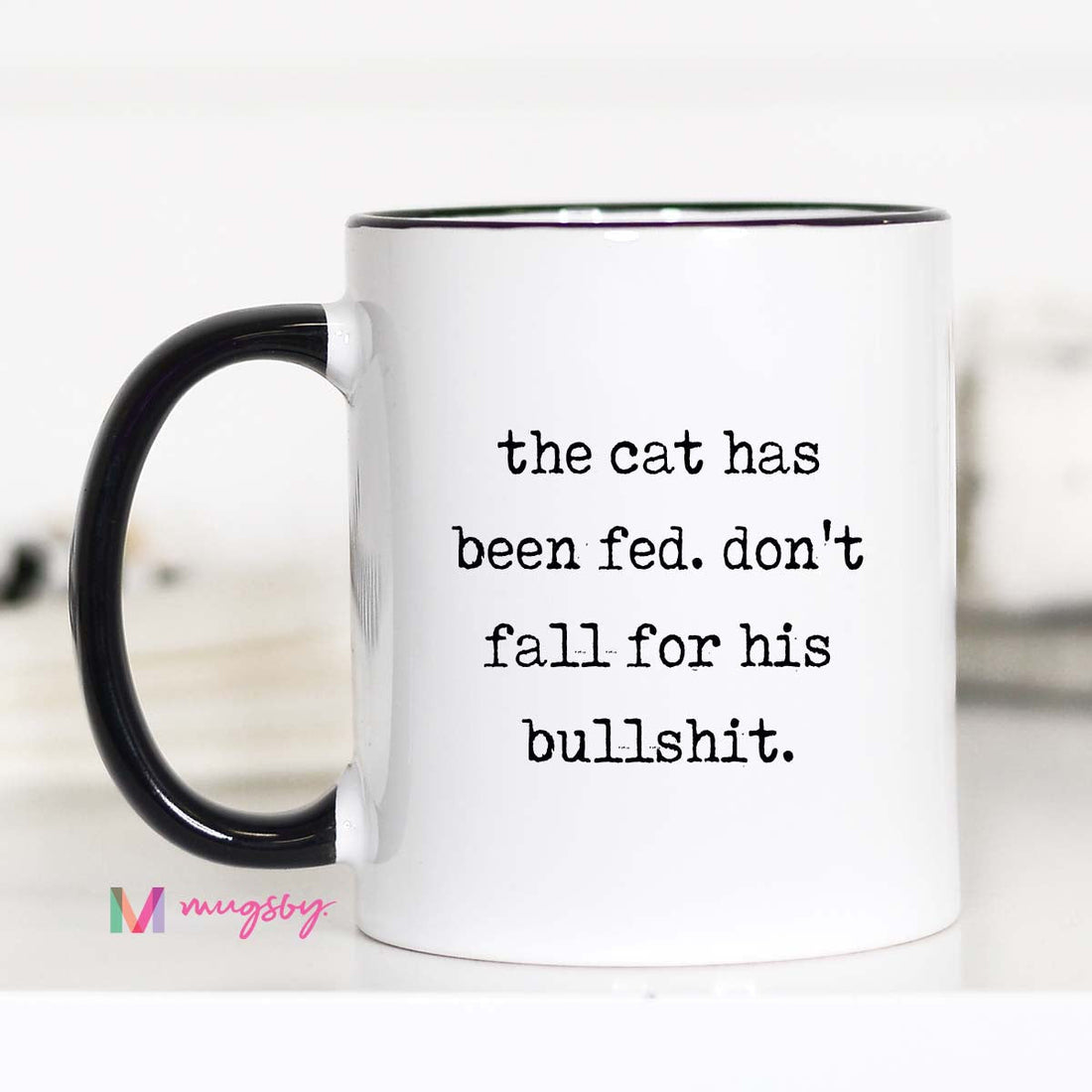 White mug with black text and black handle on a white background