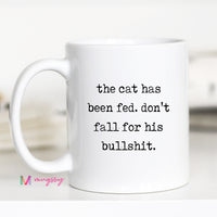 White mug with humorous text on a blurred background