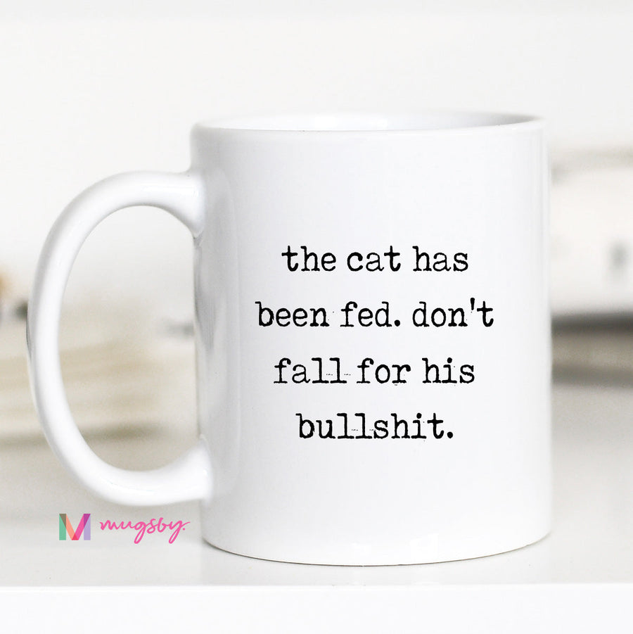 White mug with humorous text on a blurred background