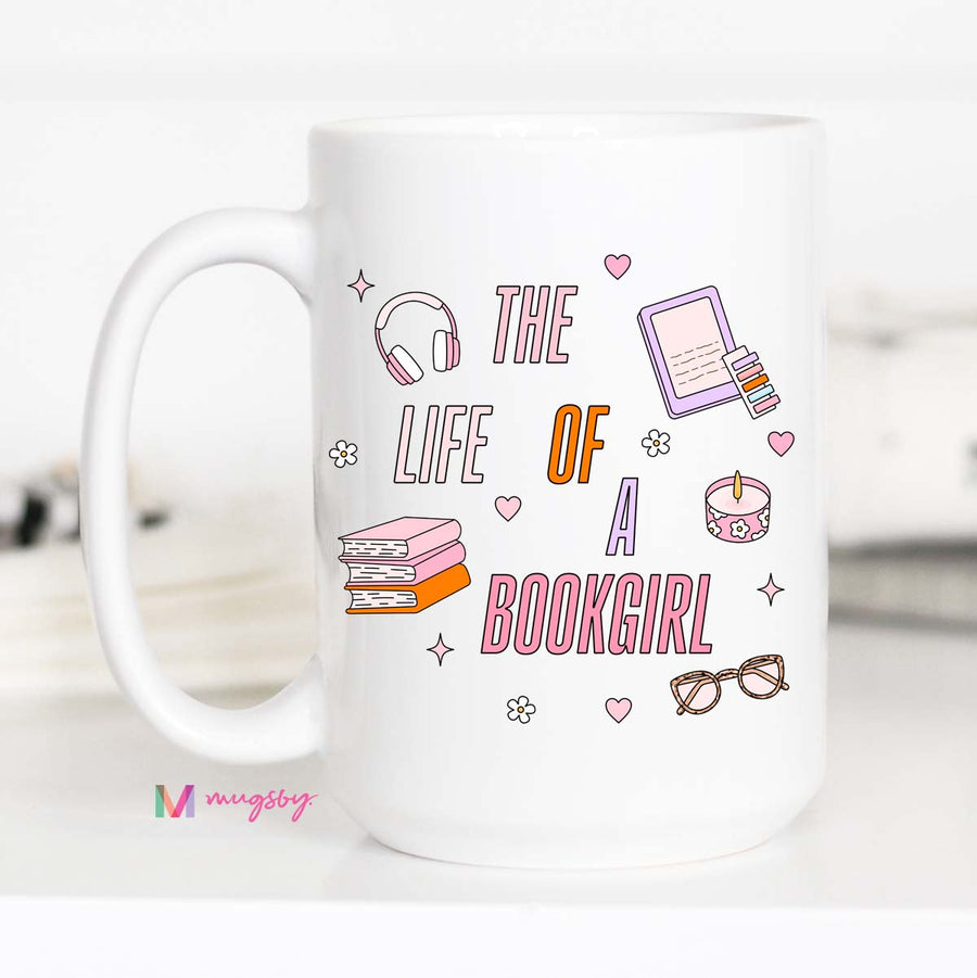 White mug with 'The Life of a Bookgirl' design featuring books, headphones, and other items on a white background.