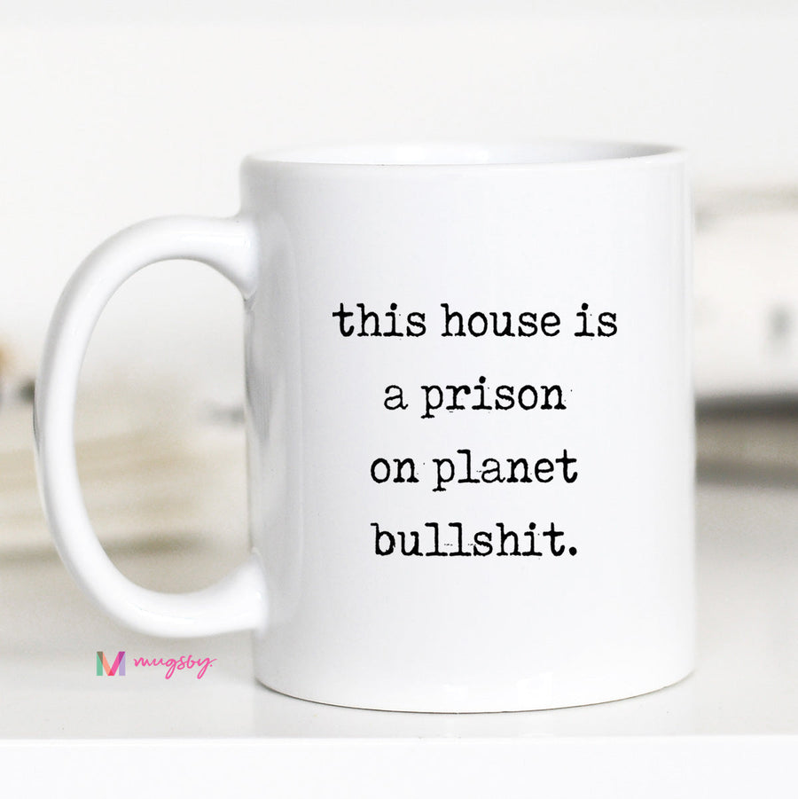 White mug with black text on a white background