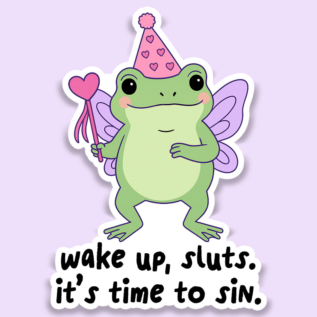 Die-cut vinyl sticker of a cute green frog wearing butterfly wings and a pink party hat holding a heart wand with the text "wake up, it&