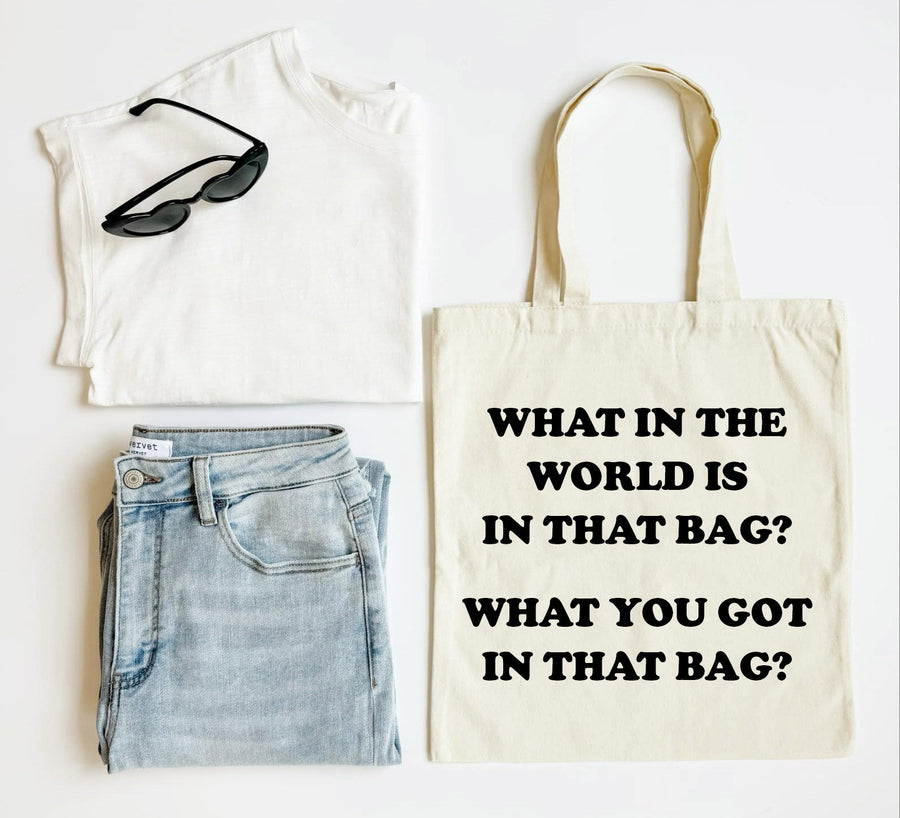 White tank top, blue jeans, black sunglasses, and a tote bag with text on a white background