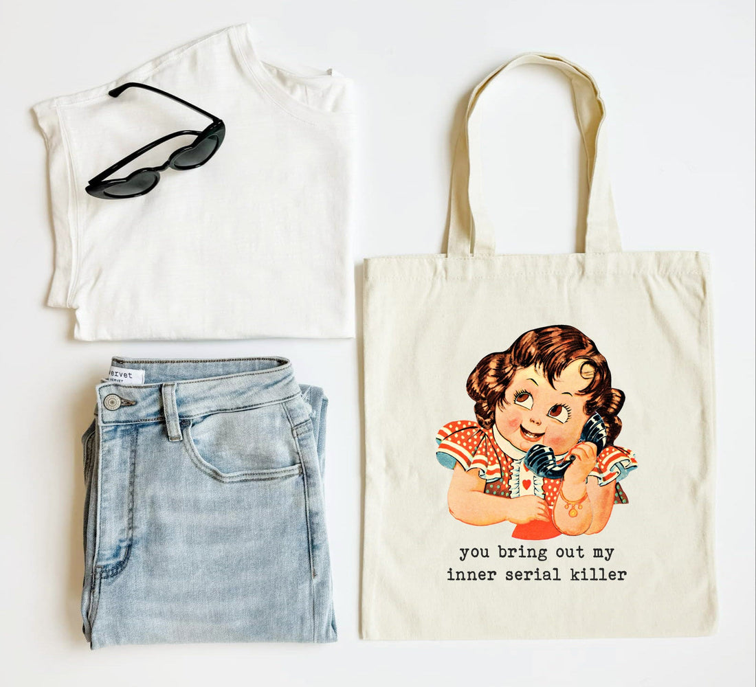 White tank top, blue jeans, sunglasses, and a tote bag with a graphic design on a white background